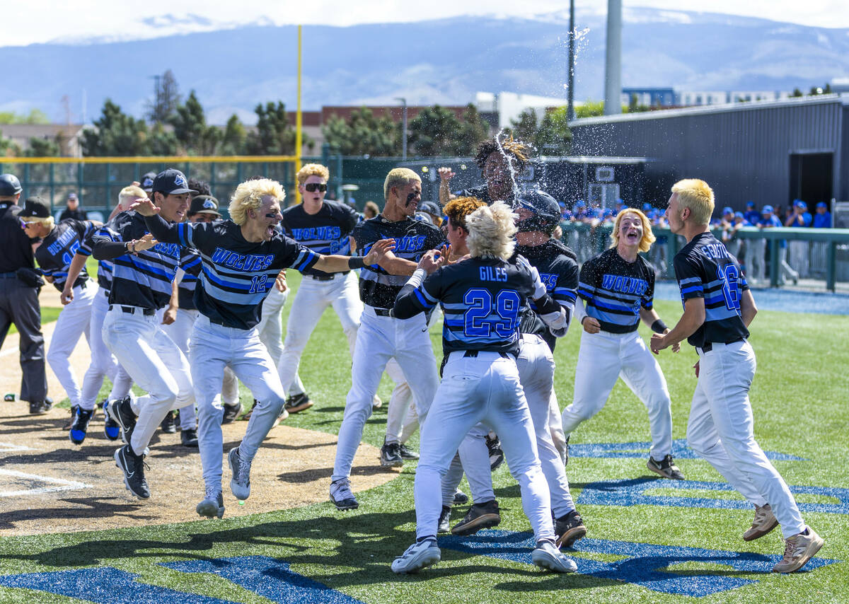 Basic players celebrate a late surge to defeat Faith Lutheran during day two of the 5A baseball ...