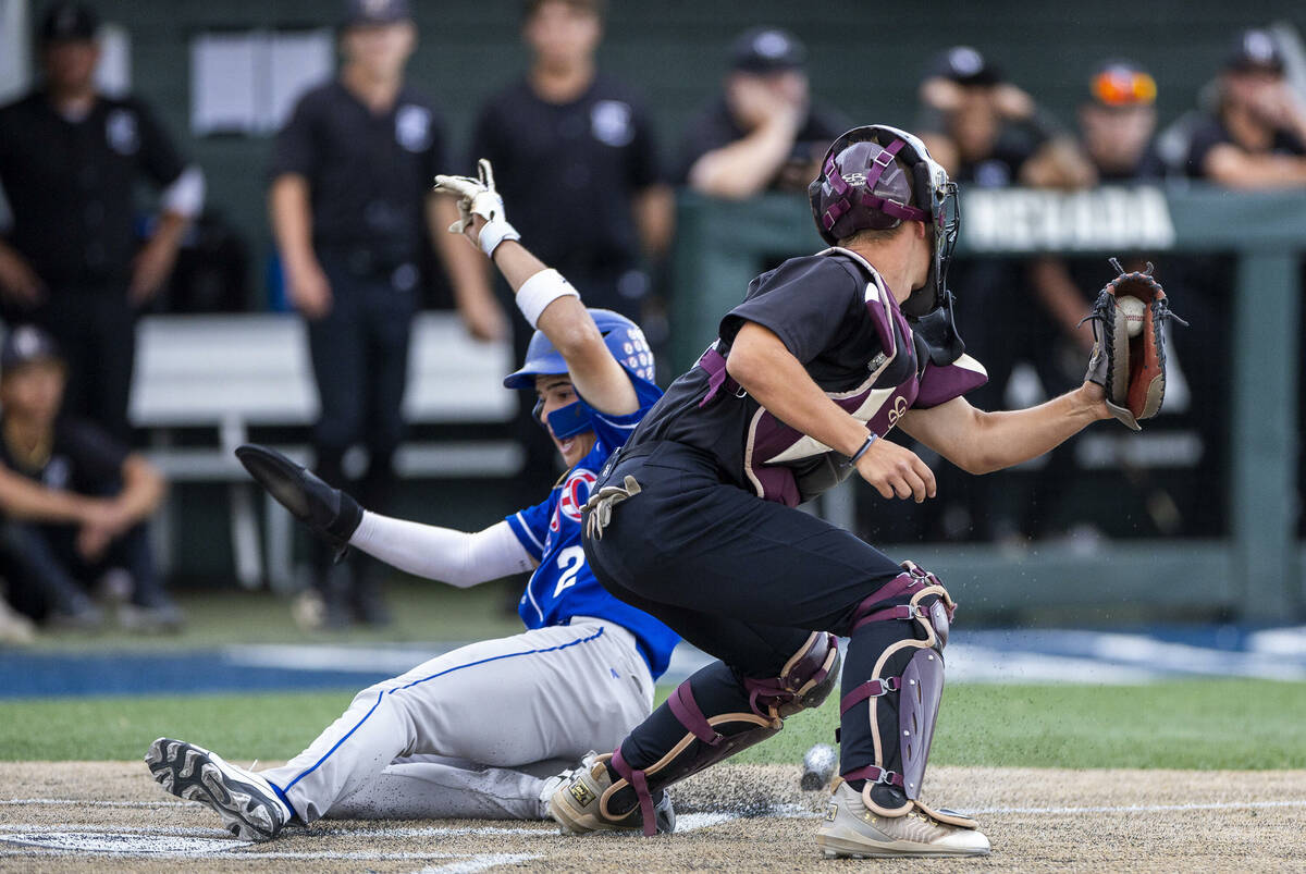 Reno runner Braden Jones (2) slides home safely past Faith Lutheran catcher Kade Gerboc-Chun (4 ...