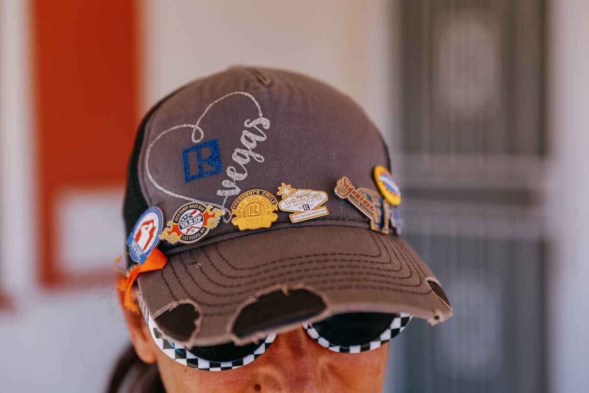 Realtor Annie Bushman wears a hat and pins commemorating the multiple events she has attended w ...