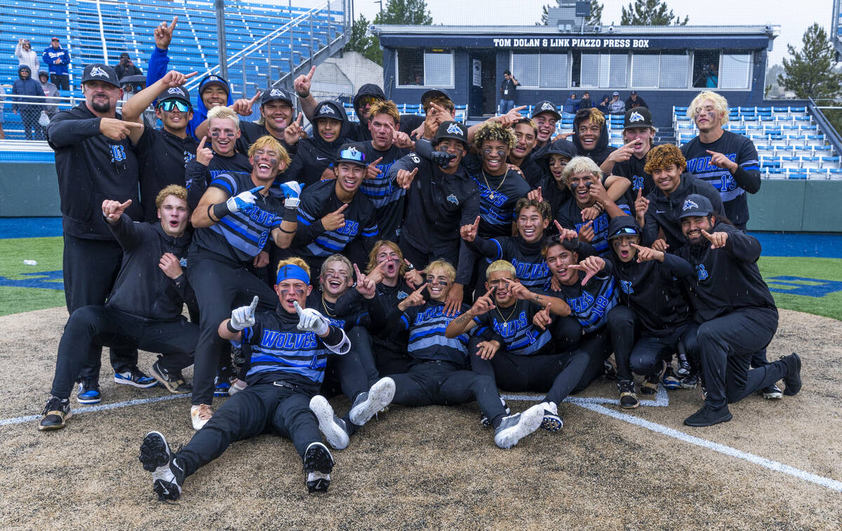 Basic players celebrate their extra-inning win against Reno to take the championship of the 5A ...