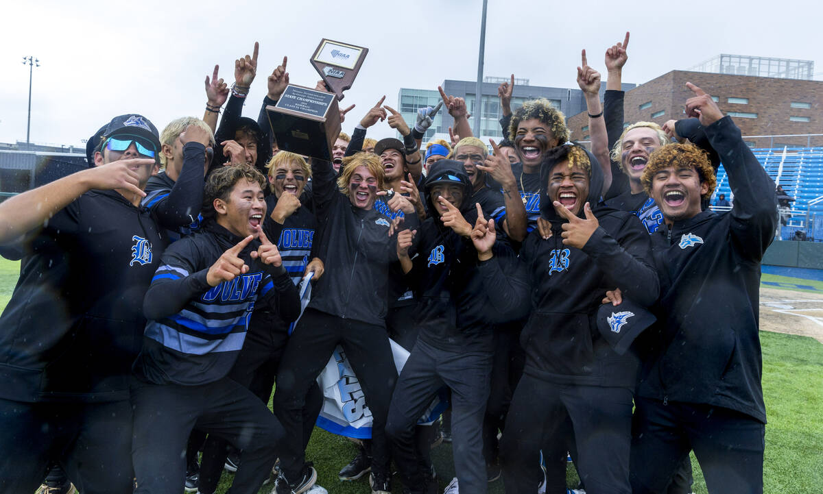 Basic players celebrate their extra-inning win against Reno with the trophy taking the champion ...