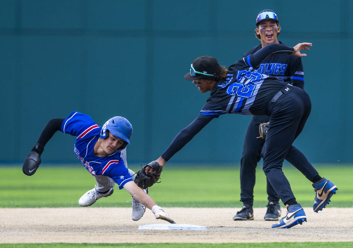 Basic infielder Matthew Kelley (23) tags out Reno runner Braden Jones (2) at second base durin ...