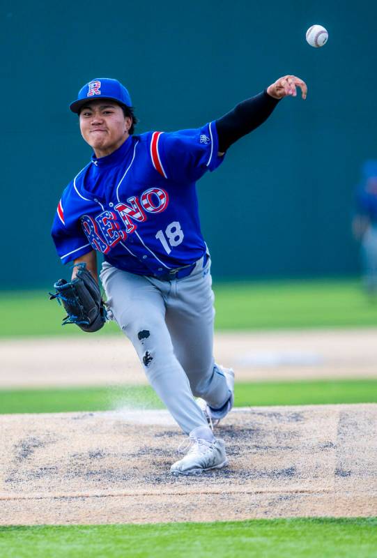 Reno pitcher Darrel Dalen (18) releases a throw to home plate and a Basic batter during the fin ...