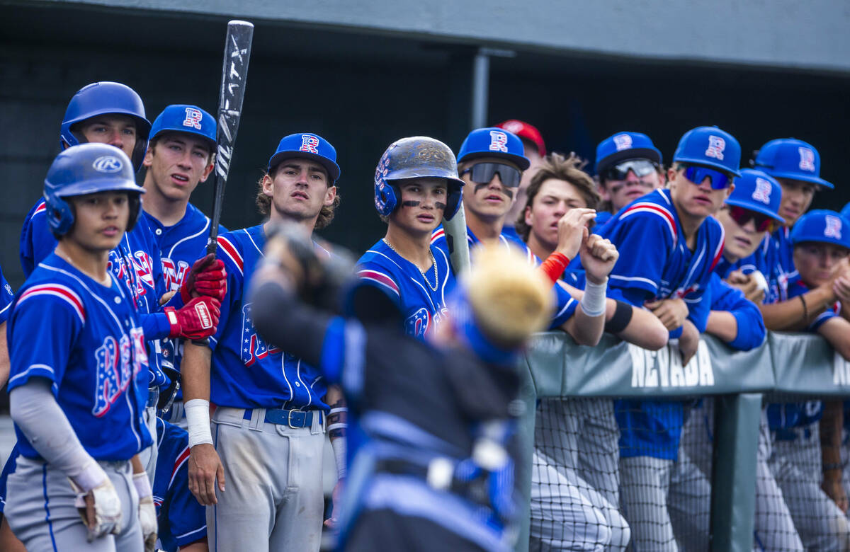 Reno players watch as Basic catcher Koa Won (4) works to grab a foul ball during the final of t ...