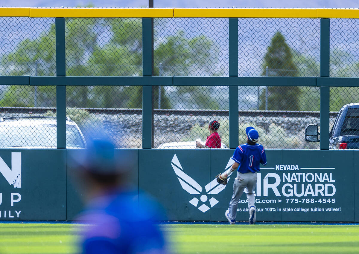 Reno outfielder Jackson Berg (1) watches as a Basic home run clears the fence during the final ...