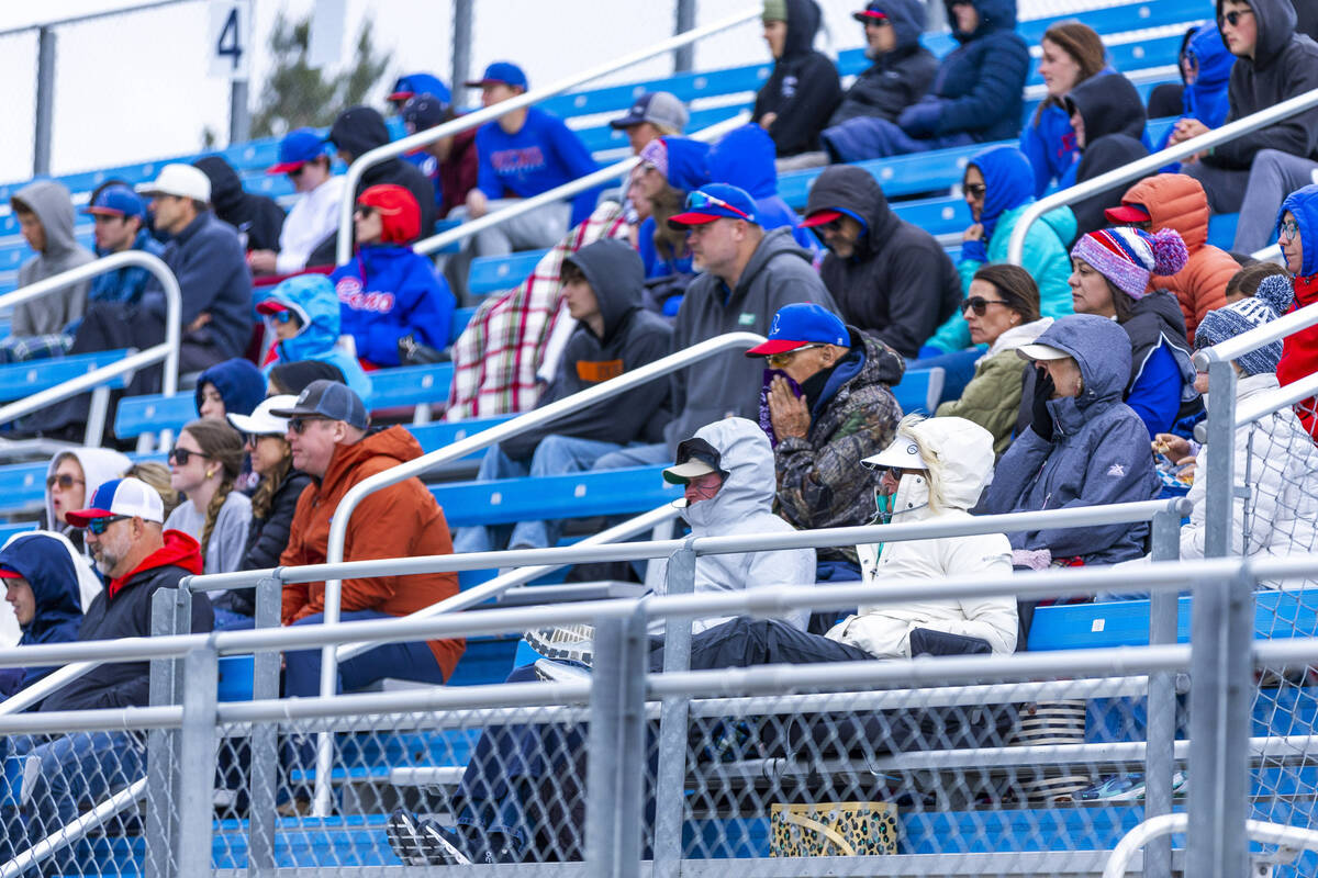 Fans attempt to stay warm and dry as Basic battles Reno during the final of the 5A baseball sta ...