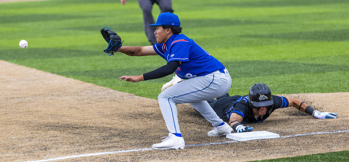 Basic runner Dallon Cegavske (24) dives safely back to first base as Reno infielder Darrel Dale ...