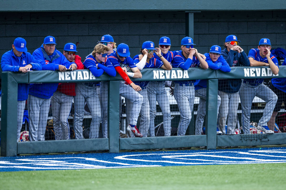 Reno players are down as Basic loads the bases in extra innings during the final of the 5A base ...