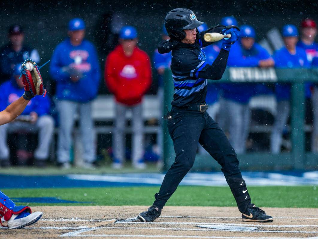Basic batter Troy Southisene (2) doesn't take a full swing against a Reno pitcher in the rain i ...