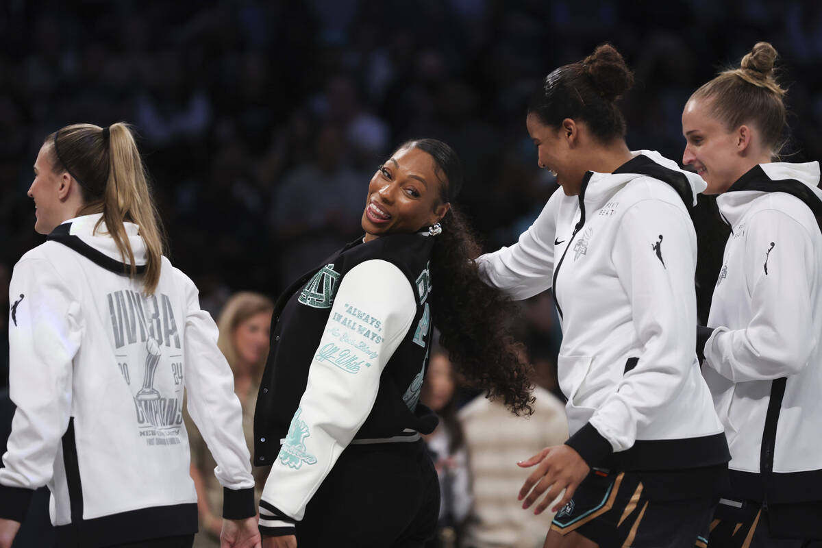 New York Liberty's Betnijah Laney-Hamilton, center, reacts with teammates before they receive t ...