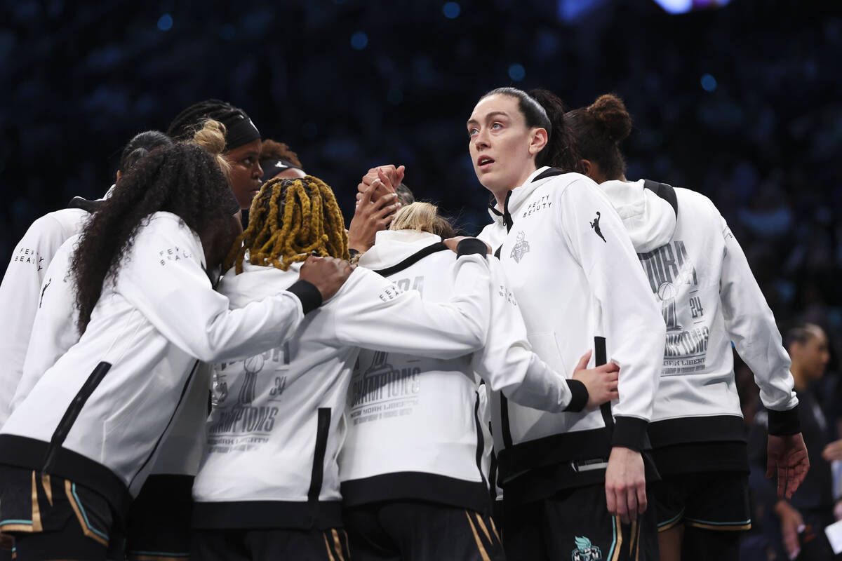 New York Liberty players including Breanna Stewart, right, huddle before the start of a WNBA ba ...
