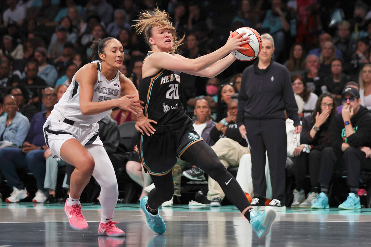 New York Liberty guard Sabrina Ionescu (20) drives to the basket as Las Vegas Aces' Aaliyah Nye ...