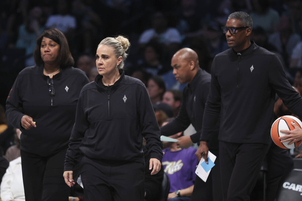 Las Vegas Aces head coach Becky Hammon, center, calls a timeout during the first half of a WNBA ...