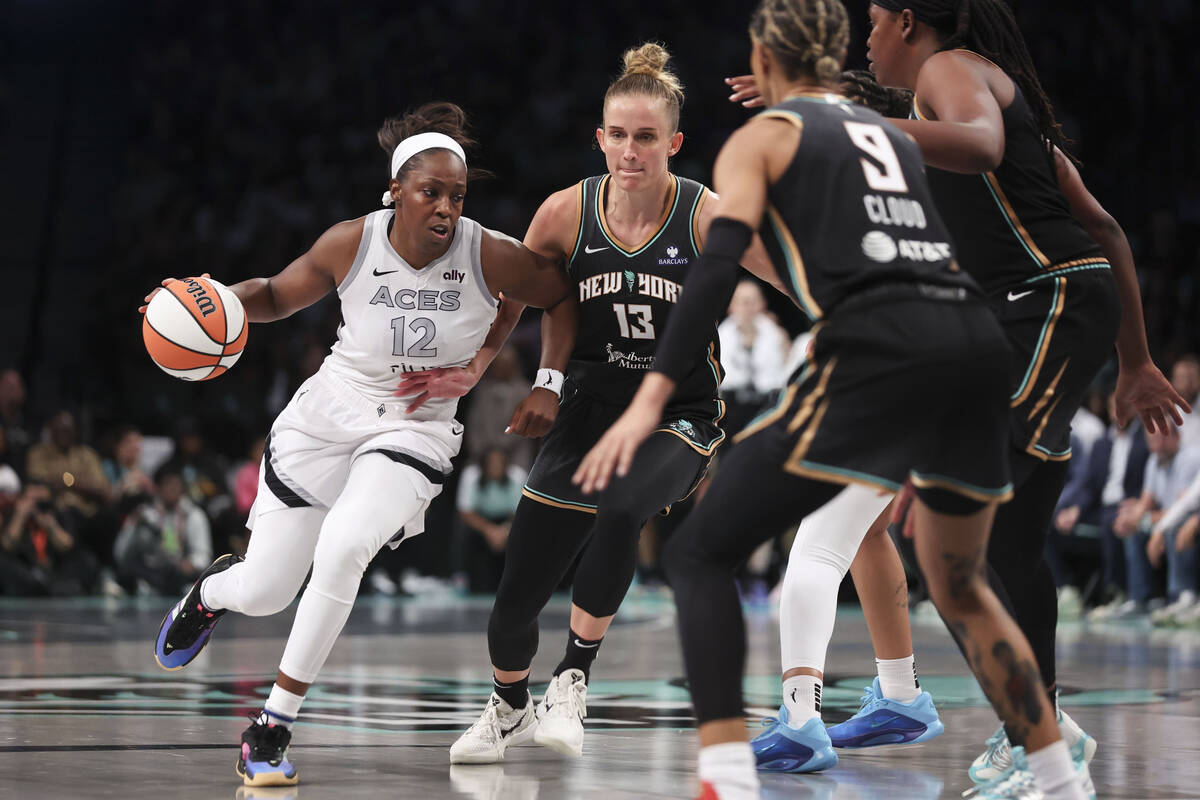 Las Vegas Aces guard Chelsea Gray (12) is surrounded by New York Liberty defenders during the s ...