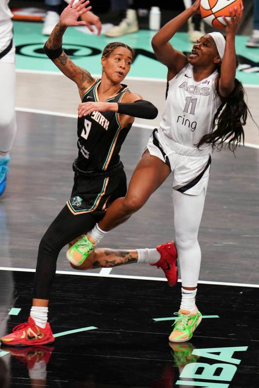 Las Vegas Aces guard Dana Evans (11) takes a shot around New York Liberty guard Natasha Cloud ( ...