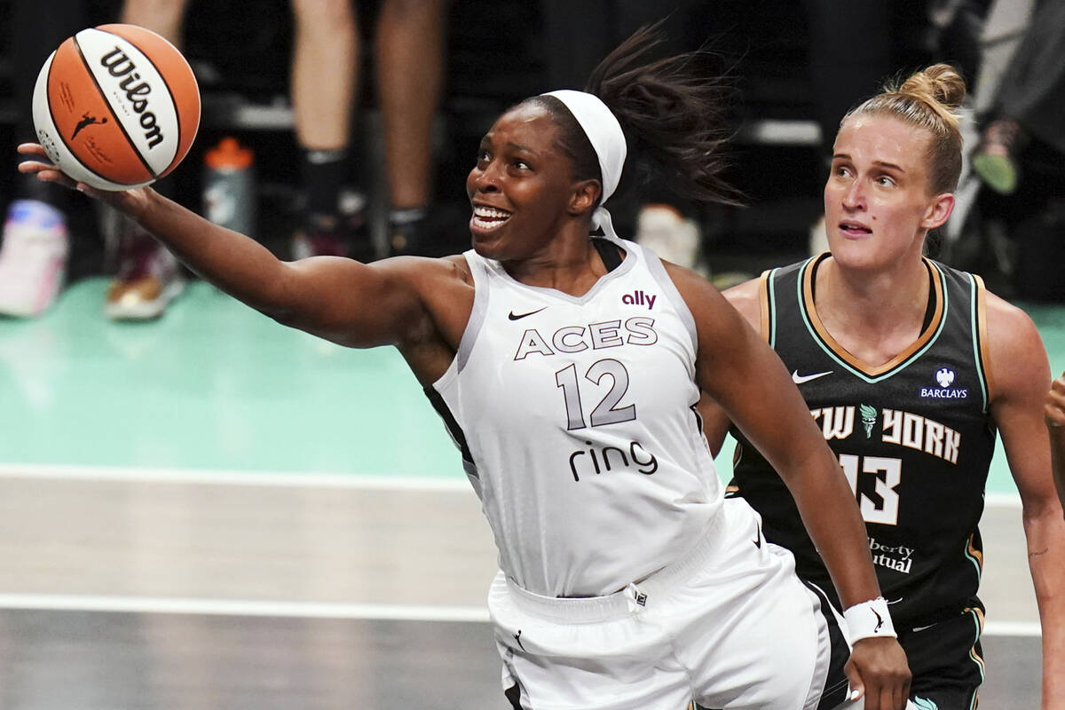 Las Vegas Aces guard Chelsea Gray (12) reaches for the ball around New York Liberty forward Leo ...