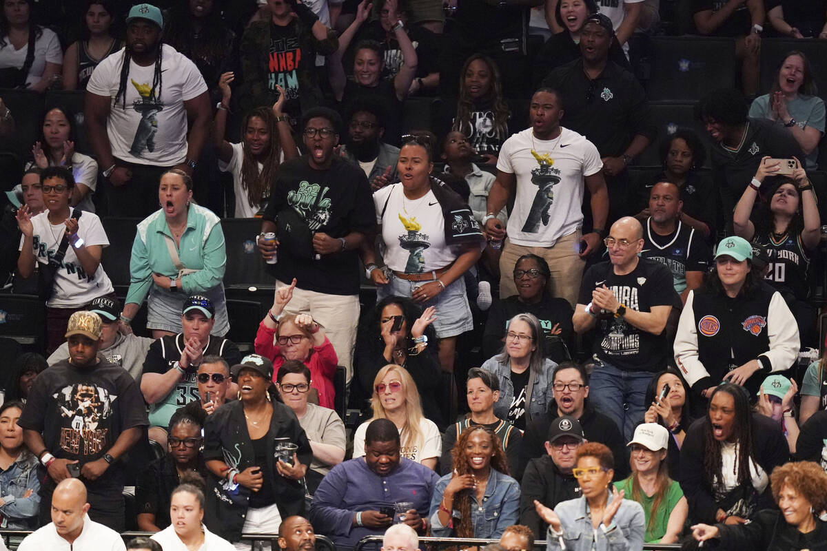 Fans cheer during a WNBA basketball game between the Las Vegas Aces and the New York Liberty in ...