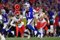 FILE - Buffalo Bills quarterback Josh Allen (17) avoids Kansas City Chiefs safety Nazeeh Johnso ...