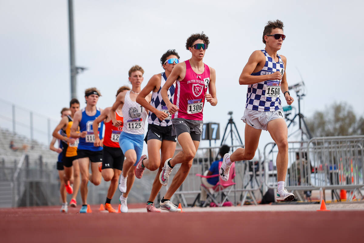 Runners turn the corner during the NIAA 5A Boys 3200-meter run final at Desert Oasis High Schoo ...