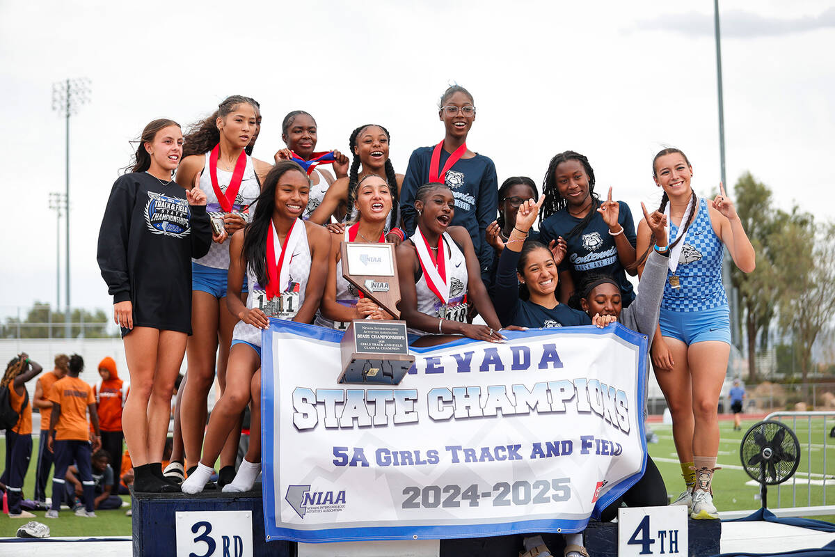 Centennial High School Girls’ track and field team pose at the podium after being named ...