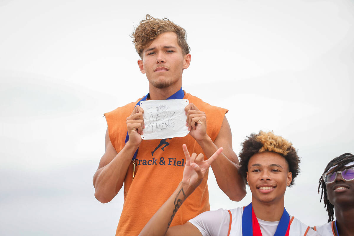 Legacy High School runner holds up a “I Need My Ring” sign after the longhorns pl ...