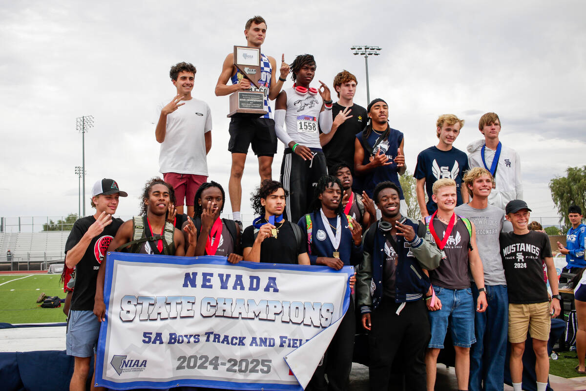 Shadow Ridge High School Boys’ track and field team pose at the podium after winning fir ...