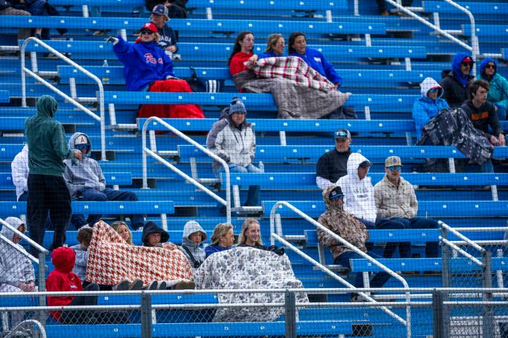 Fans are bundled up against the cold and rain as Basic battles Reno during the final of the 5A ...