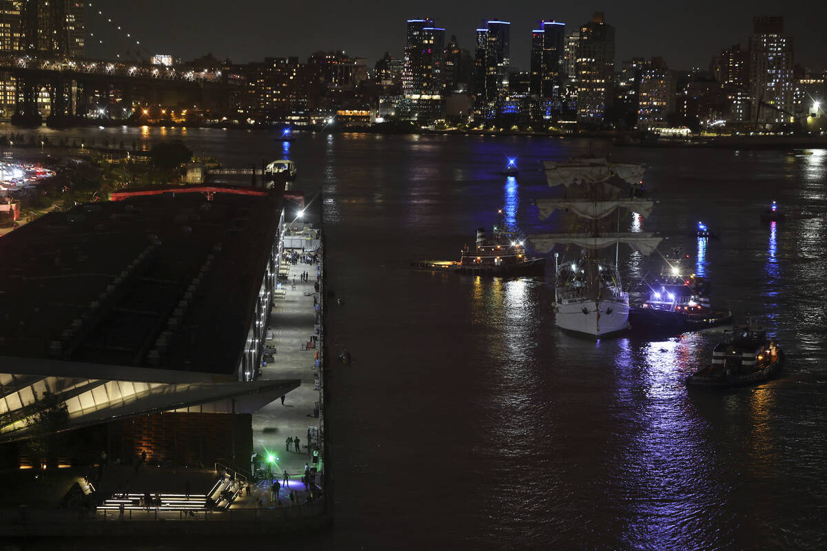 Tug boats assist the Cuauhtémoc, a masted Mexican Navy training ship, toward Pier 35 after ...
