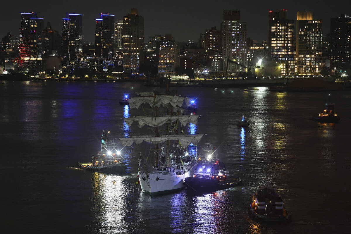 Tug boats assist the Cuauhtémoc, a masted Mexican Navy training ship, toward Pier 35 after ...