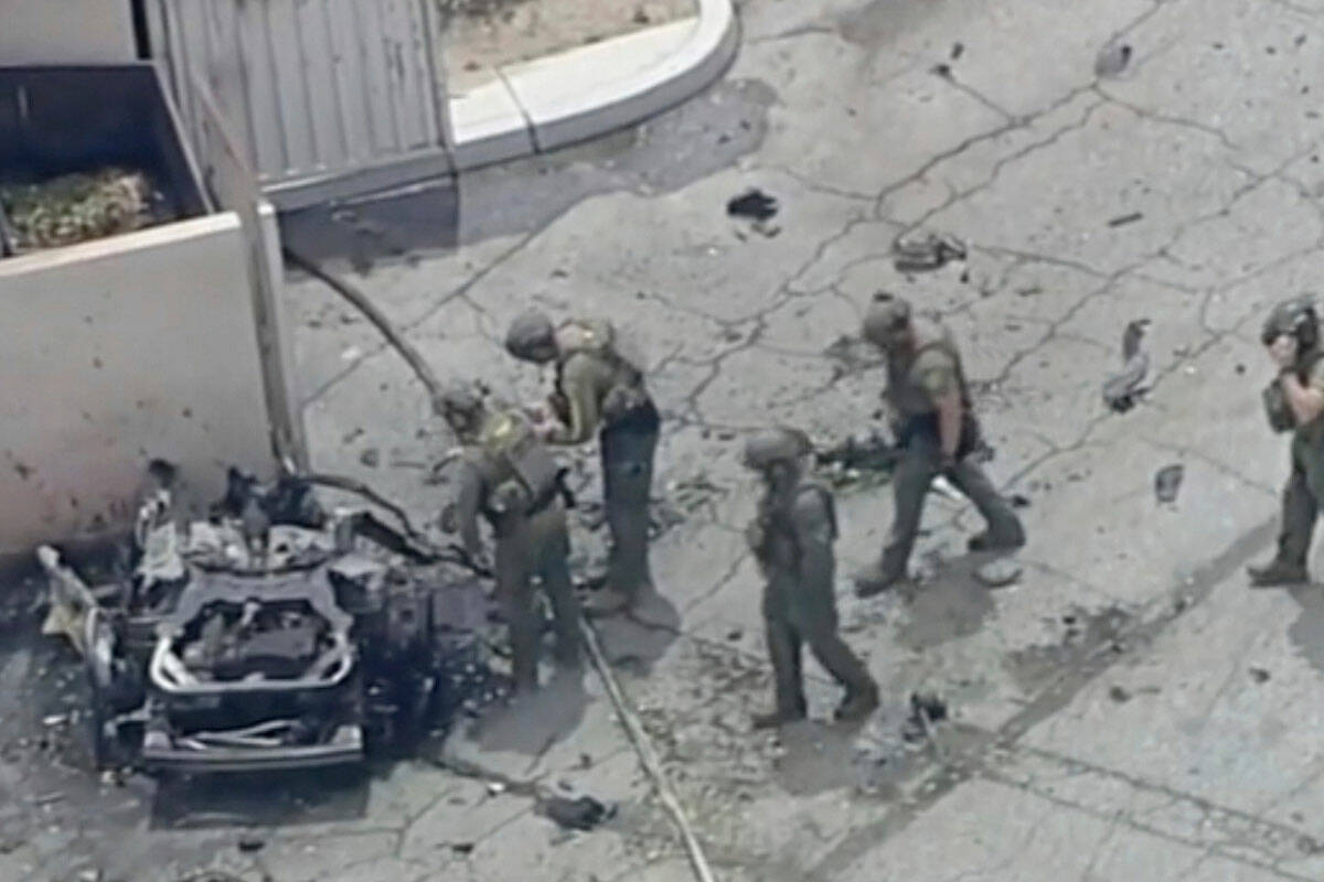 Law enforcement investigate a vehicle after an explosion on Saturday, May 17, 2025 in Palm Spri ...