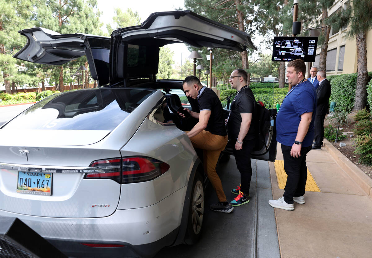 Conventioneers prepare to ride the Vegas Loop at the new Encore station in Las Vegas Tuesday, A ...