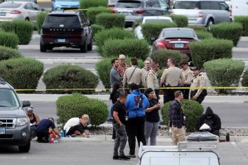 People write witness statements while Las Vegas police investigate an officer involved shooting ...