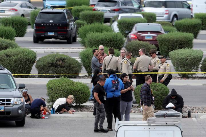 People write witness statements while Las Vegas police investigate an officer involved shooting ...