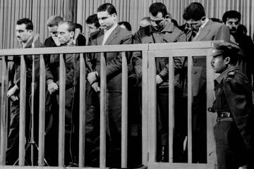 FILE - Elie Cohen, far left, head of an Israeli spy ring, listens as he is sentenced to death b ...