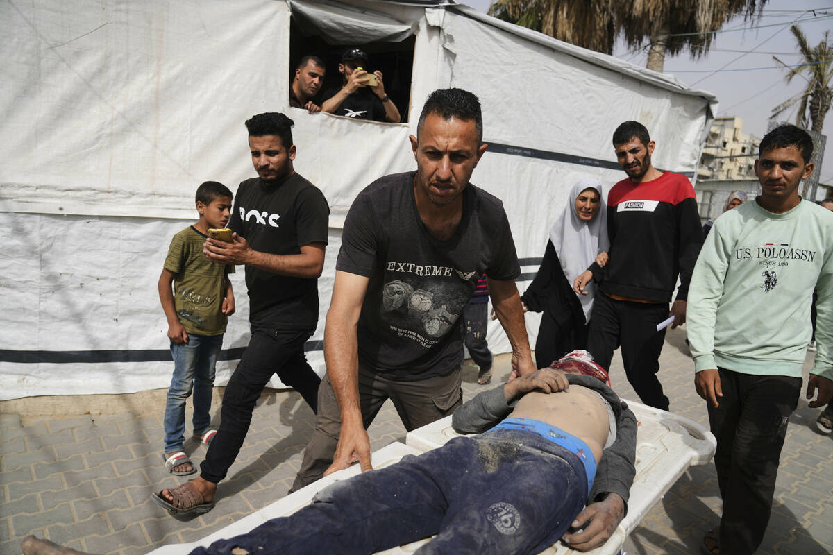 A Palestinian man killed in an Israeli airstrike on central Gaza Strip is brought to Al-Aqsa Ho ...