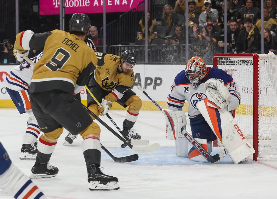 Golden Knights center Jack Eichel (9) passes the puck to center Brett Howden (21) as Edmonton O ...