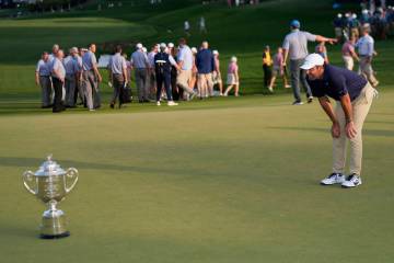 Scottie Scheffler looks at the Wanamaker trophy after winning the PGA Championship golf tournam ...