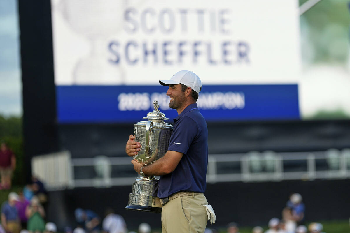 Scottie Scheffler holds the Wanamaker trophy after winning the PGA Championship golf tournament ...
