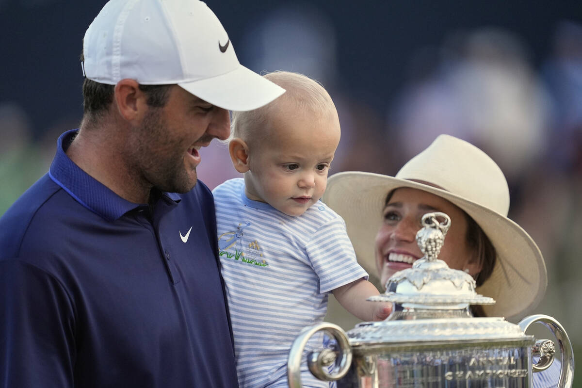 Scottie Scheffler, his wife Meredith pose with their son Bennett after winning the PGA Champion ...
