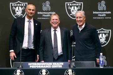 Raiders owner Mark Davis, center, poses for a photo after introducing their new general manager ...