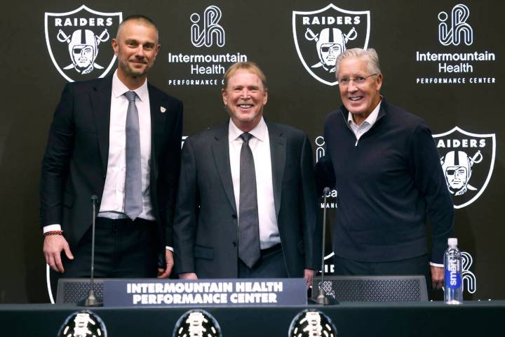Raiders owner Mark Davis, center, poses for a photo after introducing their new general manager ...