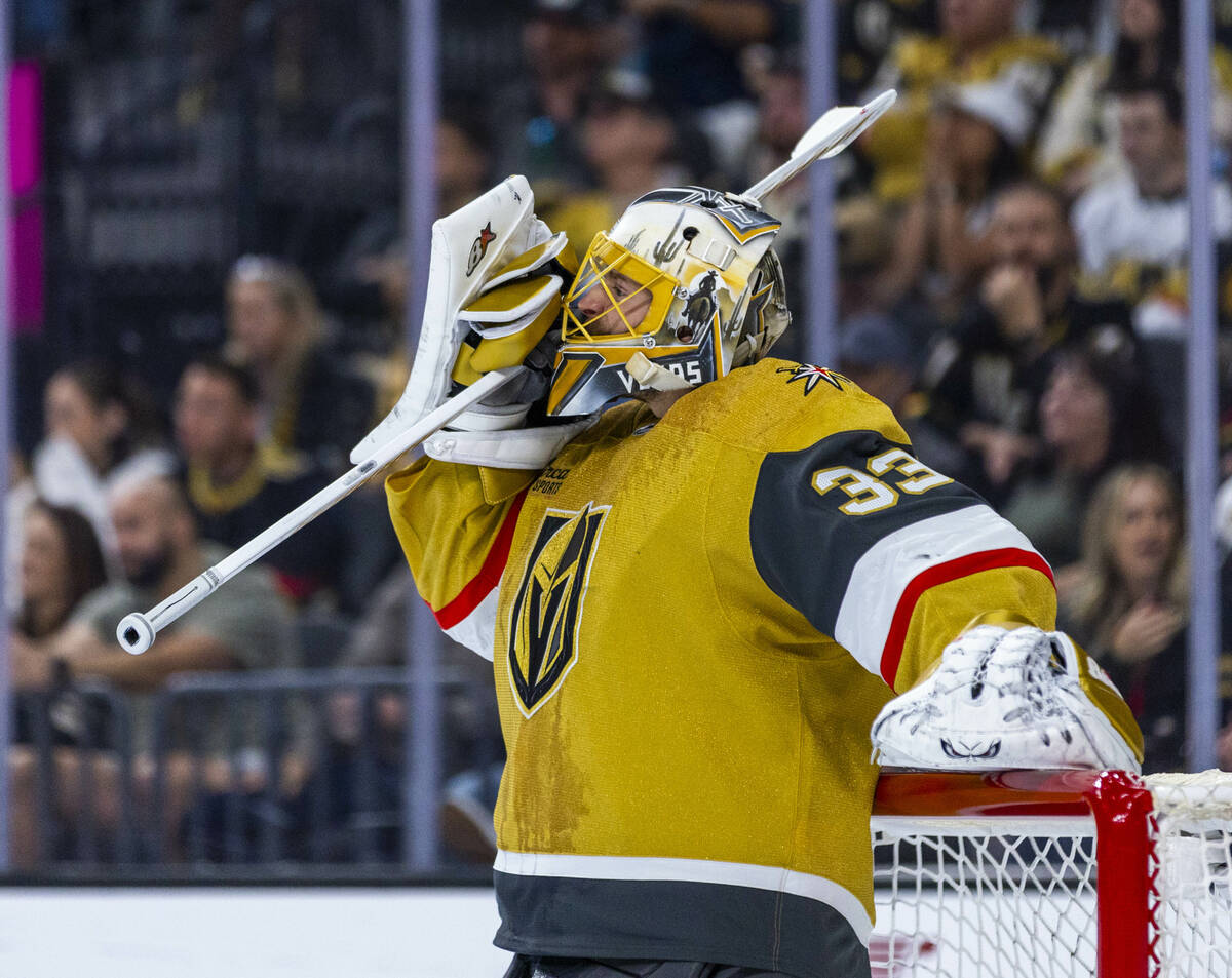 Golden Knights goaltender Adin Hill (33) adjusts his helmet after taking a hit against the Edmo ...