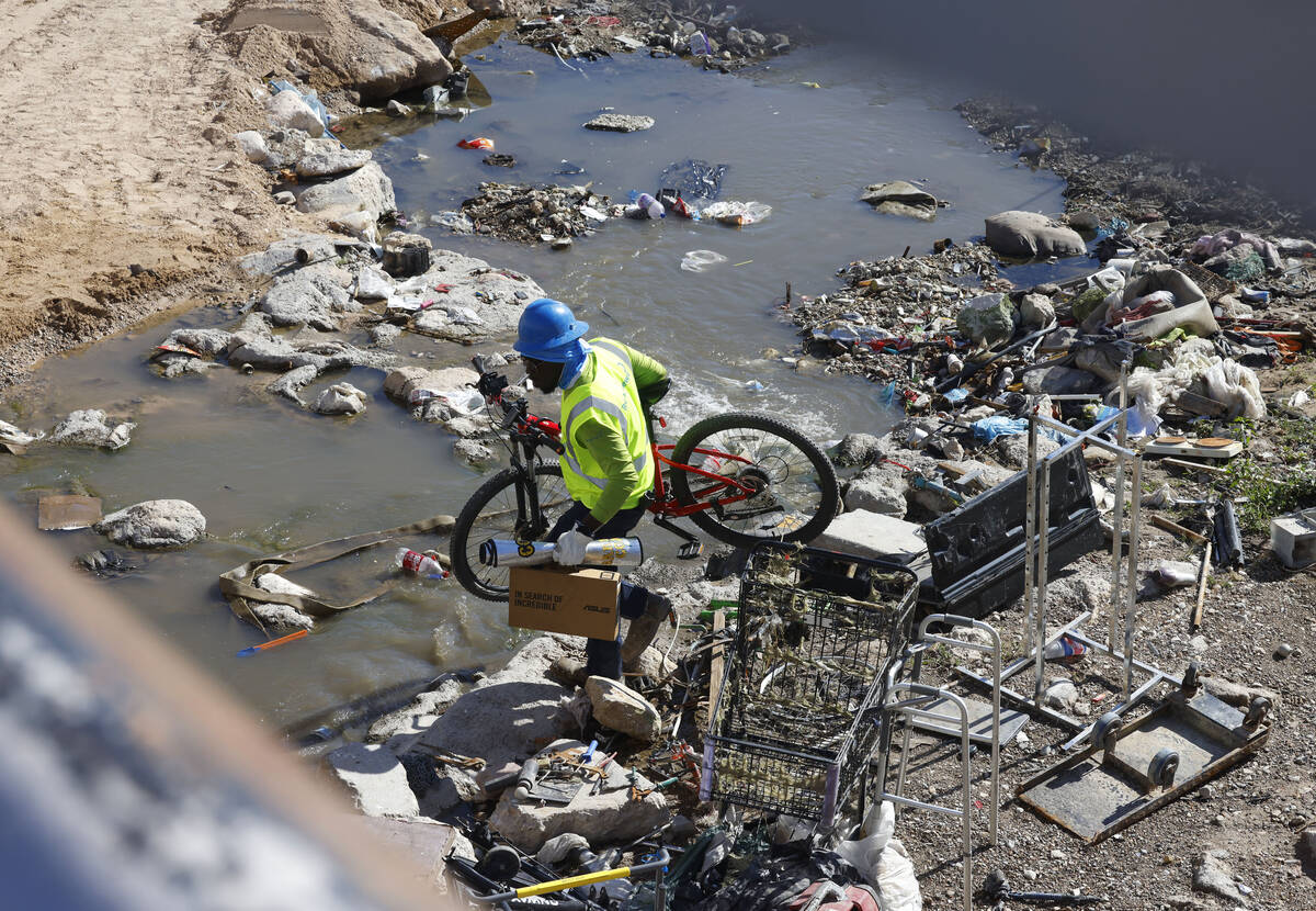 A contract worker removes items from the wash area at the corner of Flamingo Road and Cambridge ...