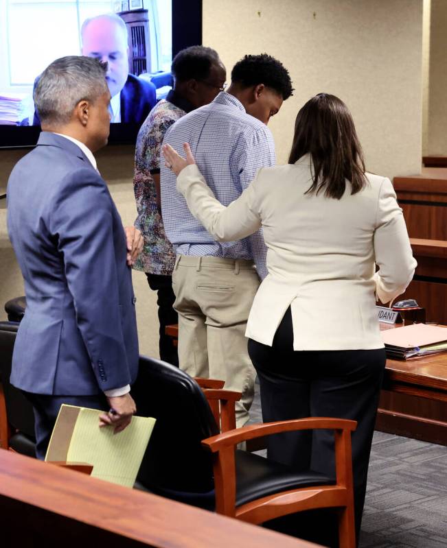 Former UNLV basketball recruit Zaon Collins, center, is comforted by his attorney Stephanie Zin ...