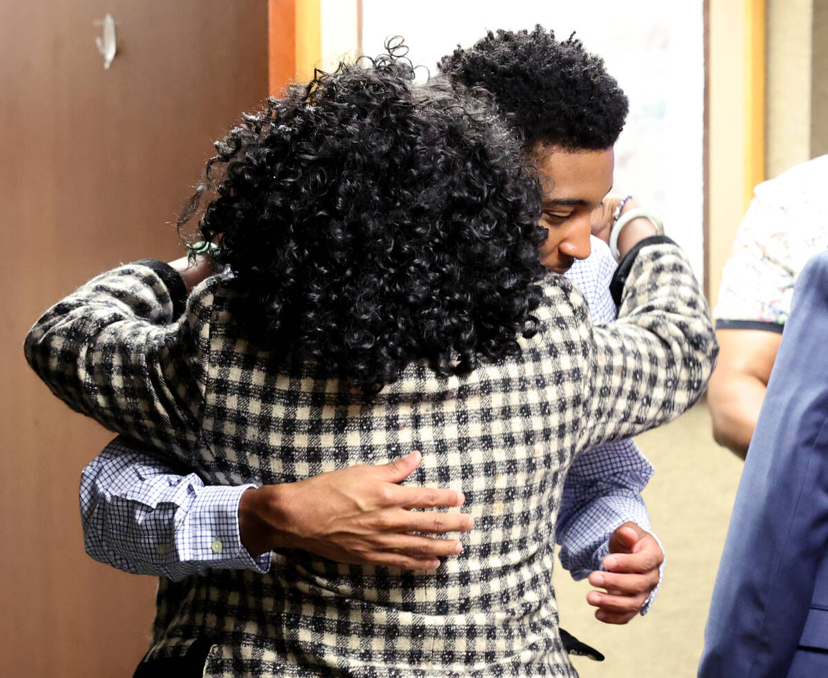 Former UNLV basketball recruit Zaon Collins hugs one of his attorneys after the verdicts in his ...