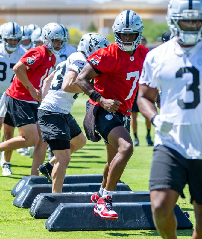 Raiders quarterback Geno Smith (7) runs a drill with teammates during Raiders OTA practice at t ...
