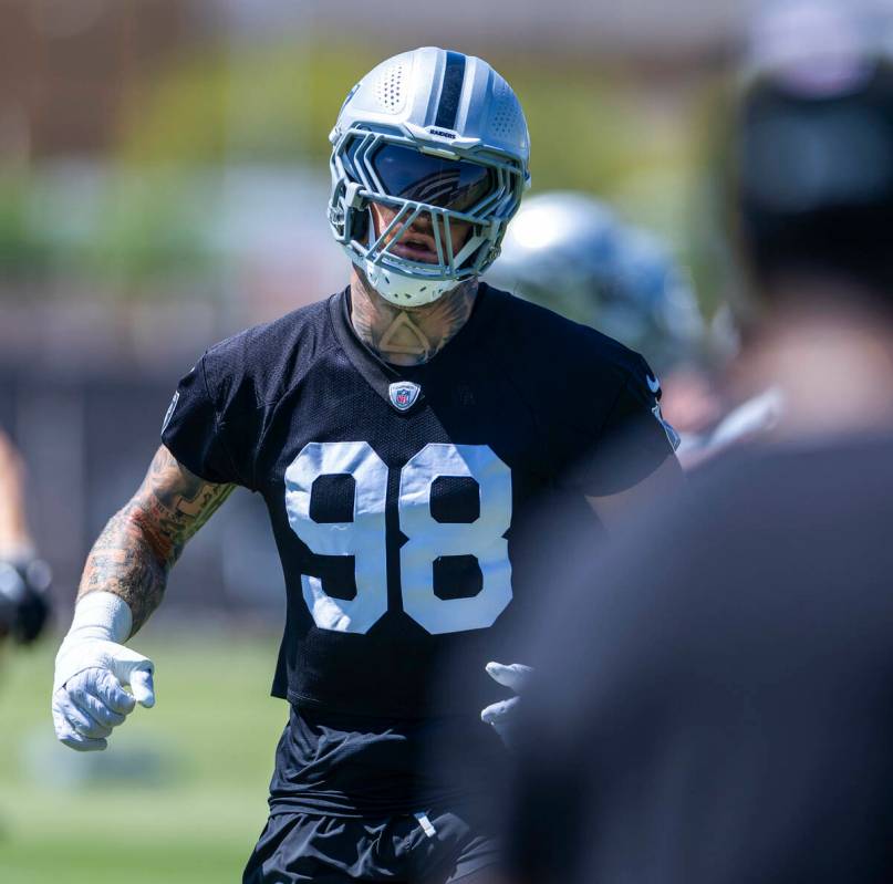 Raiders defensive end Max Crosby (98) runs a warm up drill with teammates during Raiders OTA pr ...
