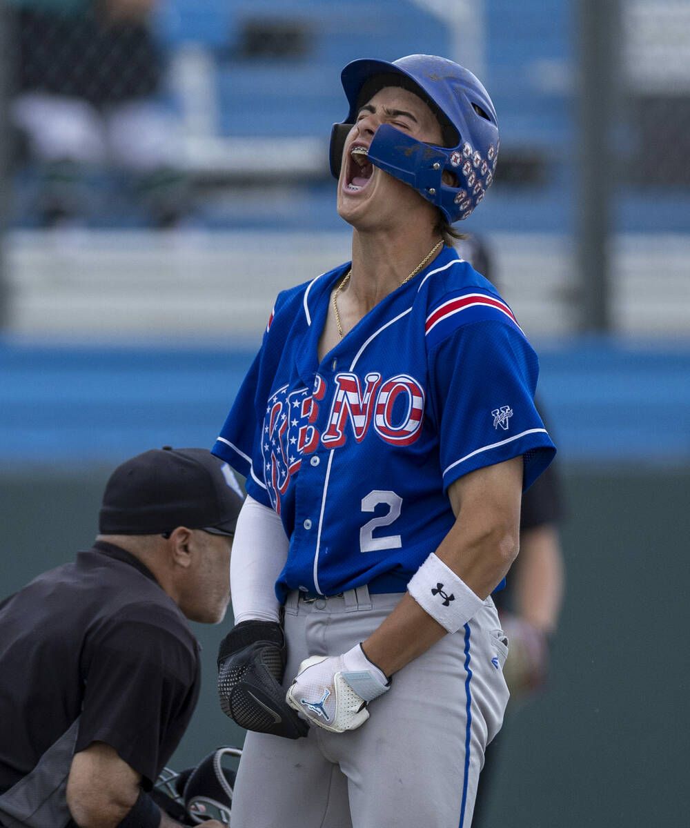 Reno runner Braden Jones (2) celebrates scoring against Faith Lutheran catcher Kade Gerboc-Chun ...