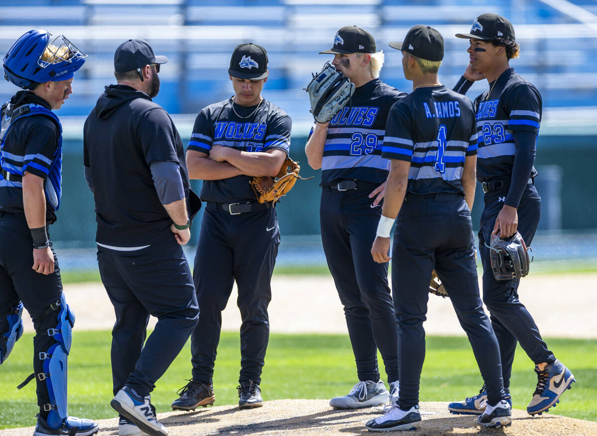 Basic players and their coach talk strategy on the mound on a timeout against Reno during the f ...