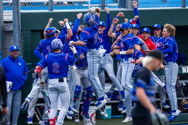 Reno players celebrate their first score of the game against Basic during the final of the 5A b ...